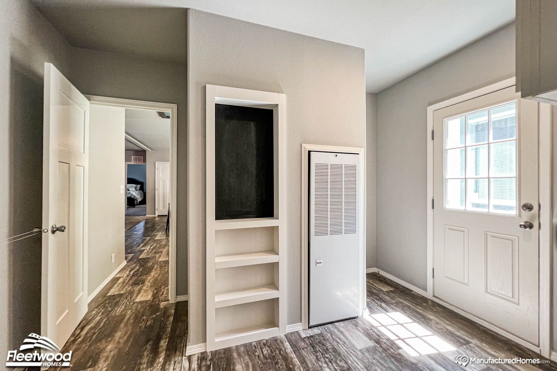 Entryway with wooden floors and built-in wall storage shelves.
