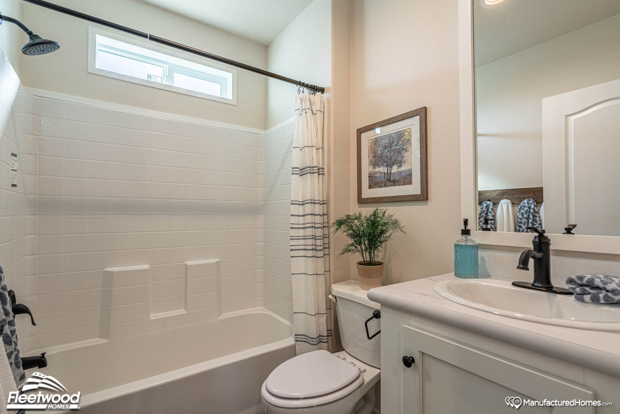 Mid-sized bathroom with a bathtub-shower combination and a single-sink countertop.