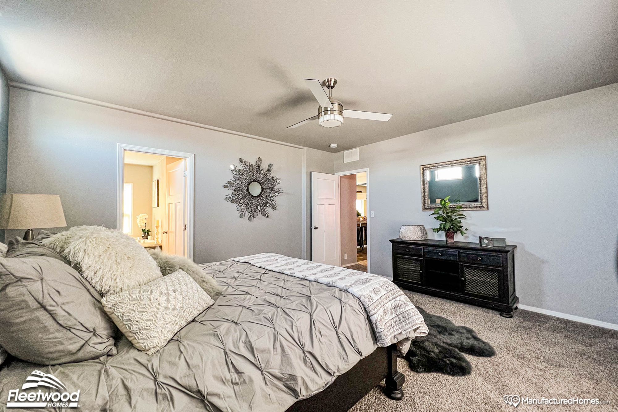 Large bedroom with a full bed, two side tables, and a connected bathroom.