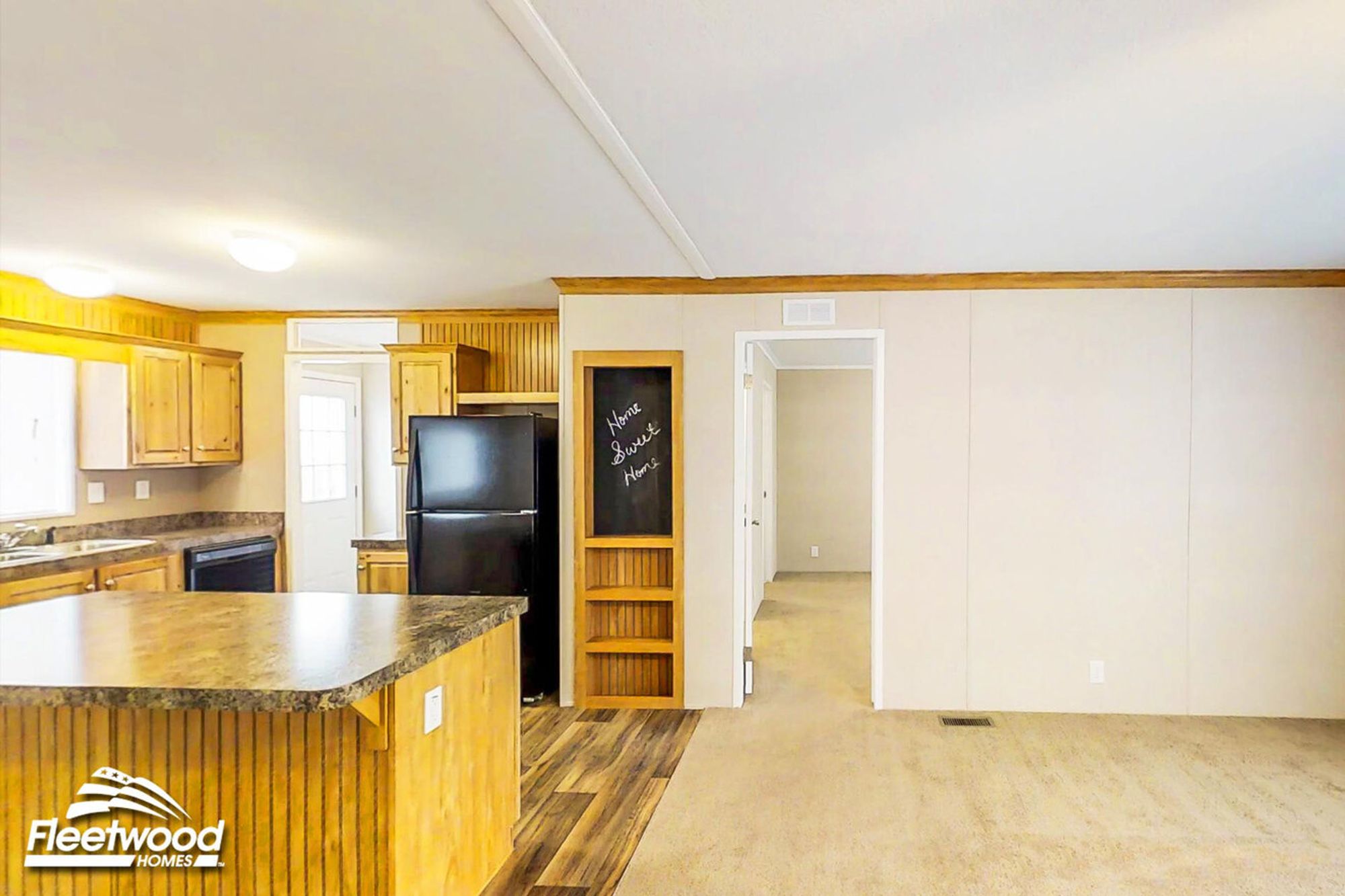 Cozy kitchen with wood cabinetry, island counter, and a chalkboard nook.