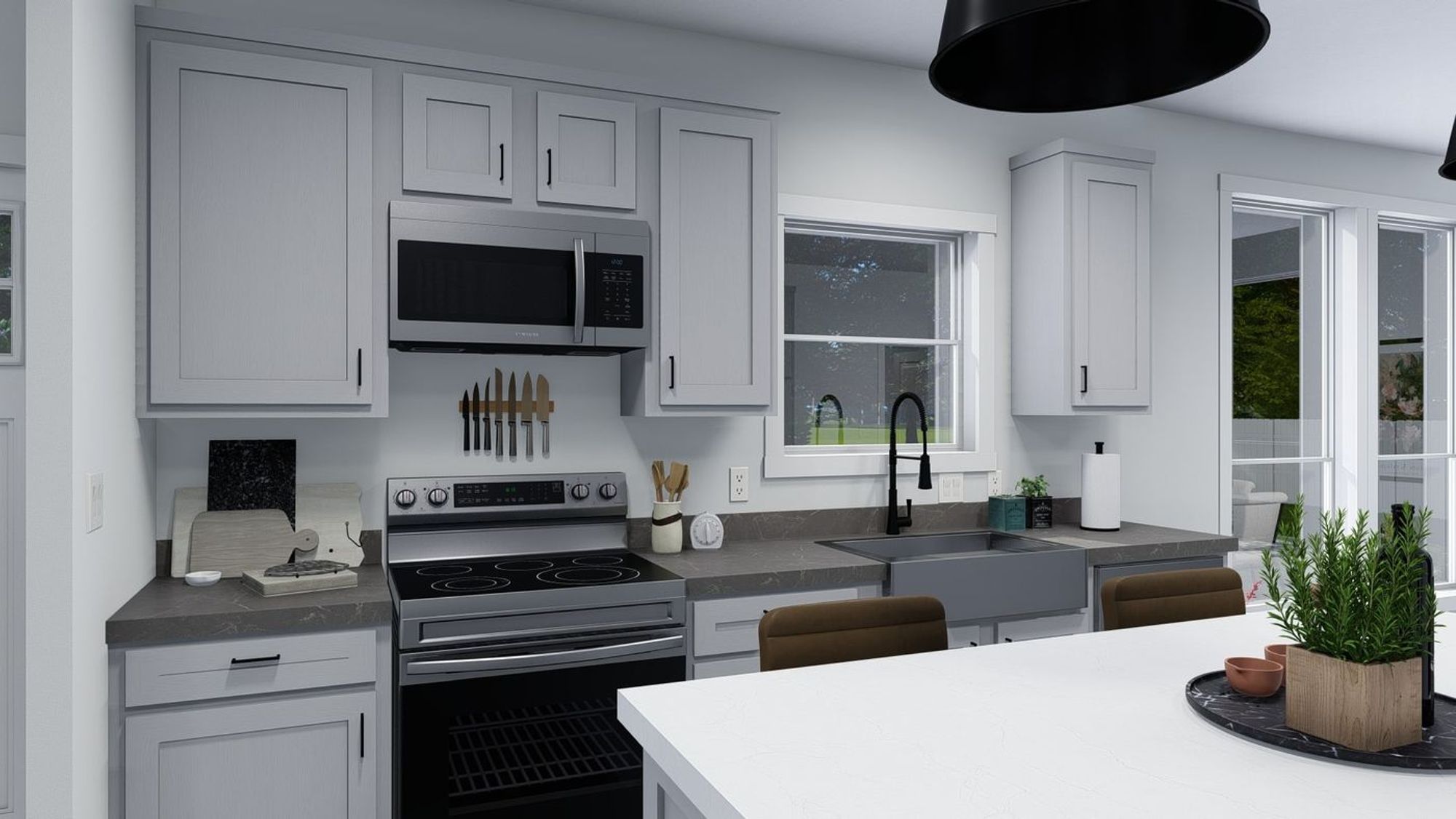 Medium-sized kitchen with silver appliances, a farmhouse sink, and an island with a white countertop.