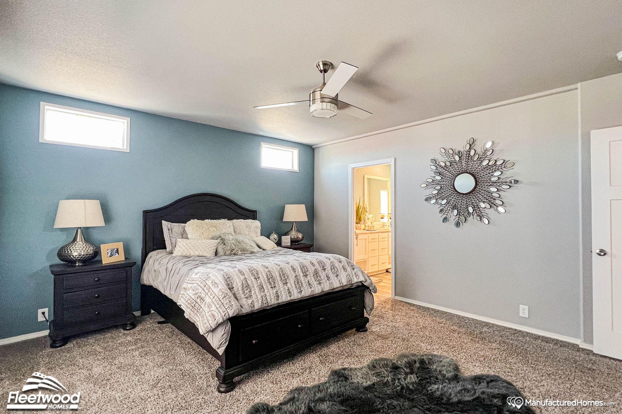 Large bedroom with a full bed, two side tables, and a connected bathroom.
