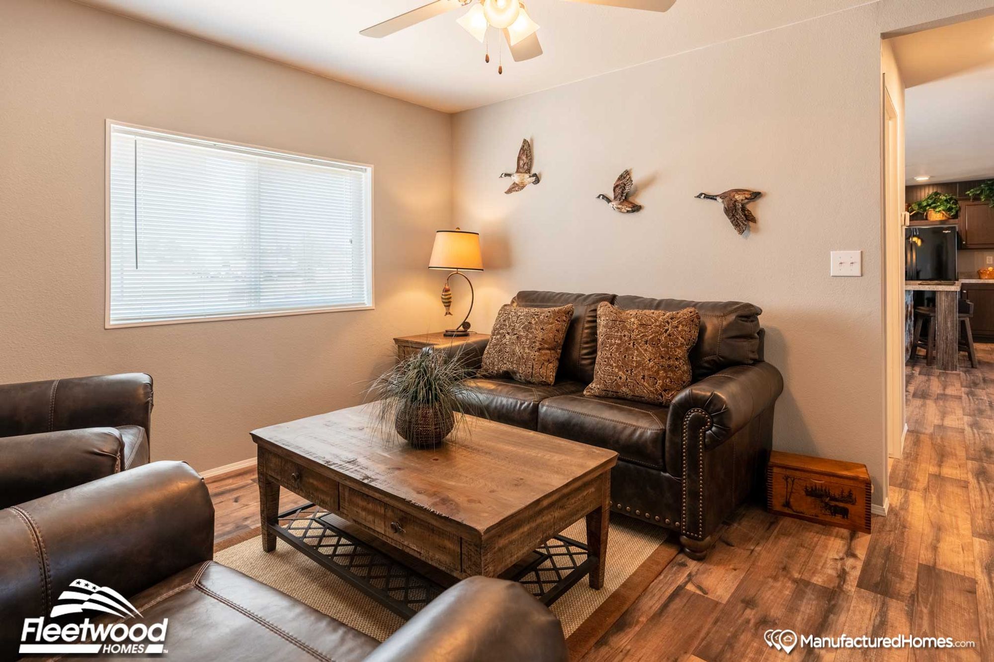 Mid-sized living room with a couch, a coffee table, a side table, and two chairs.