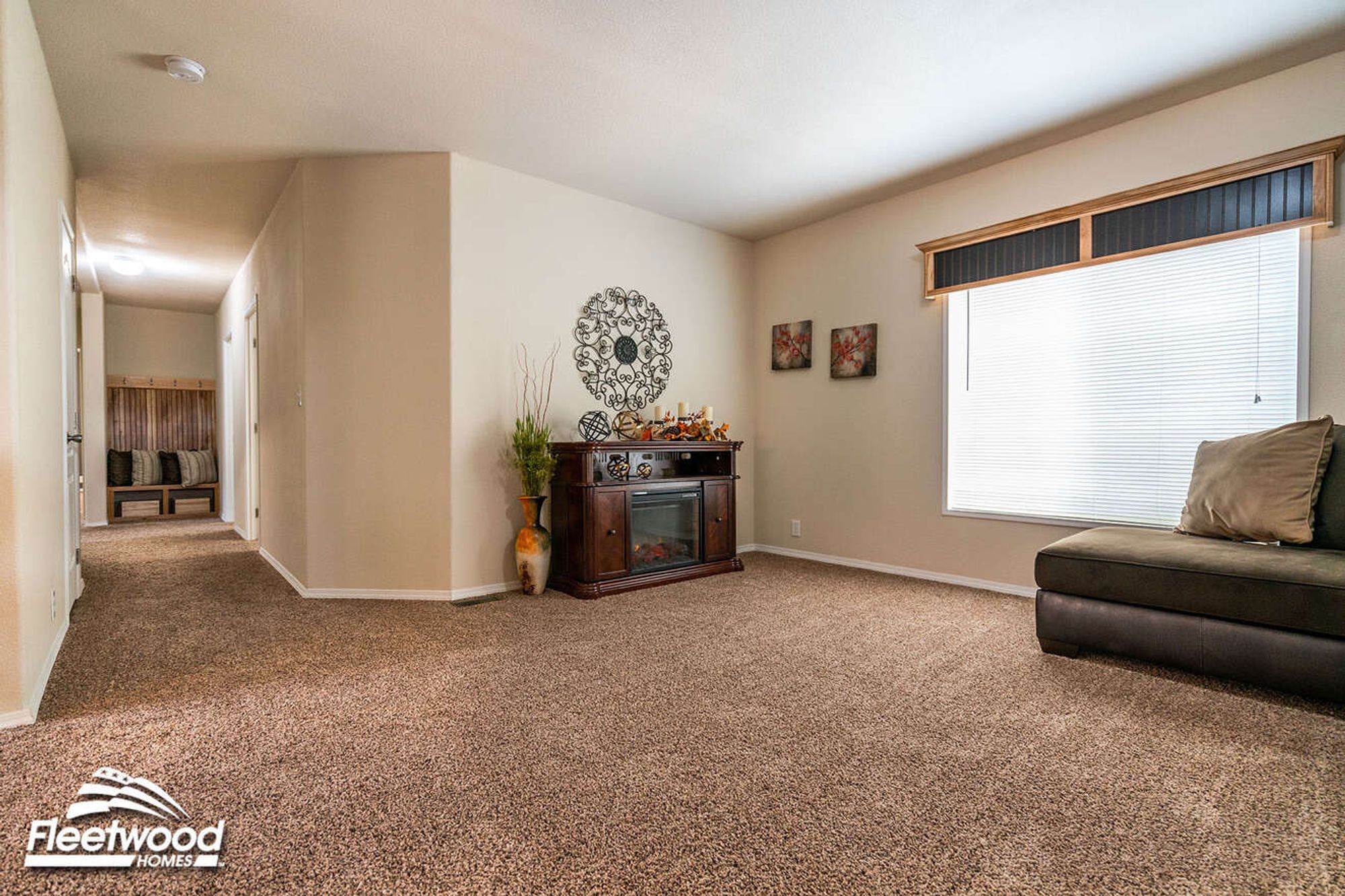 Large open living room with a partial view of a couch and a fire place.