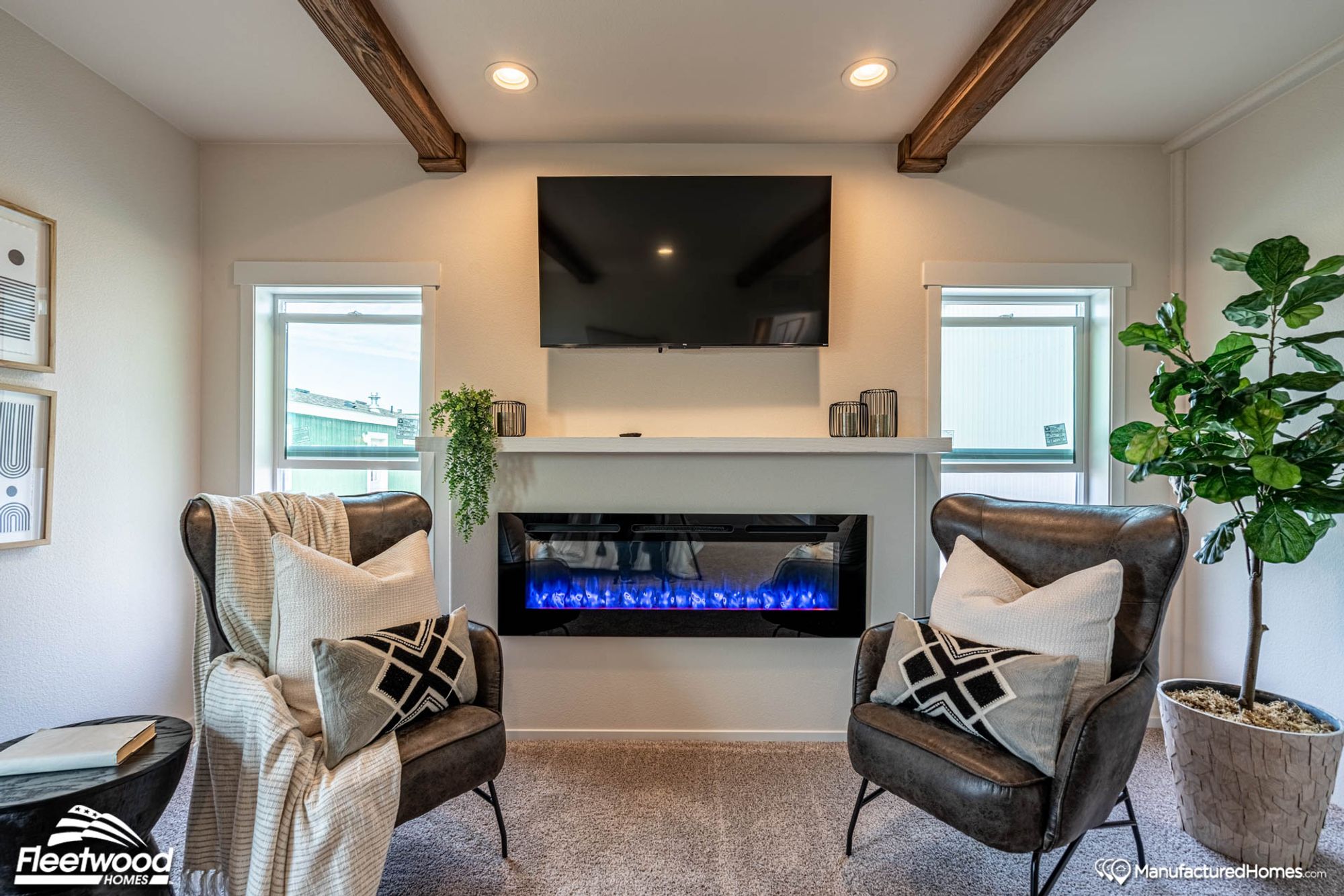 Room with two chairs and a fireplace.
