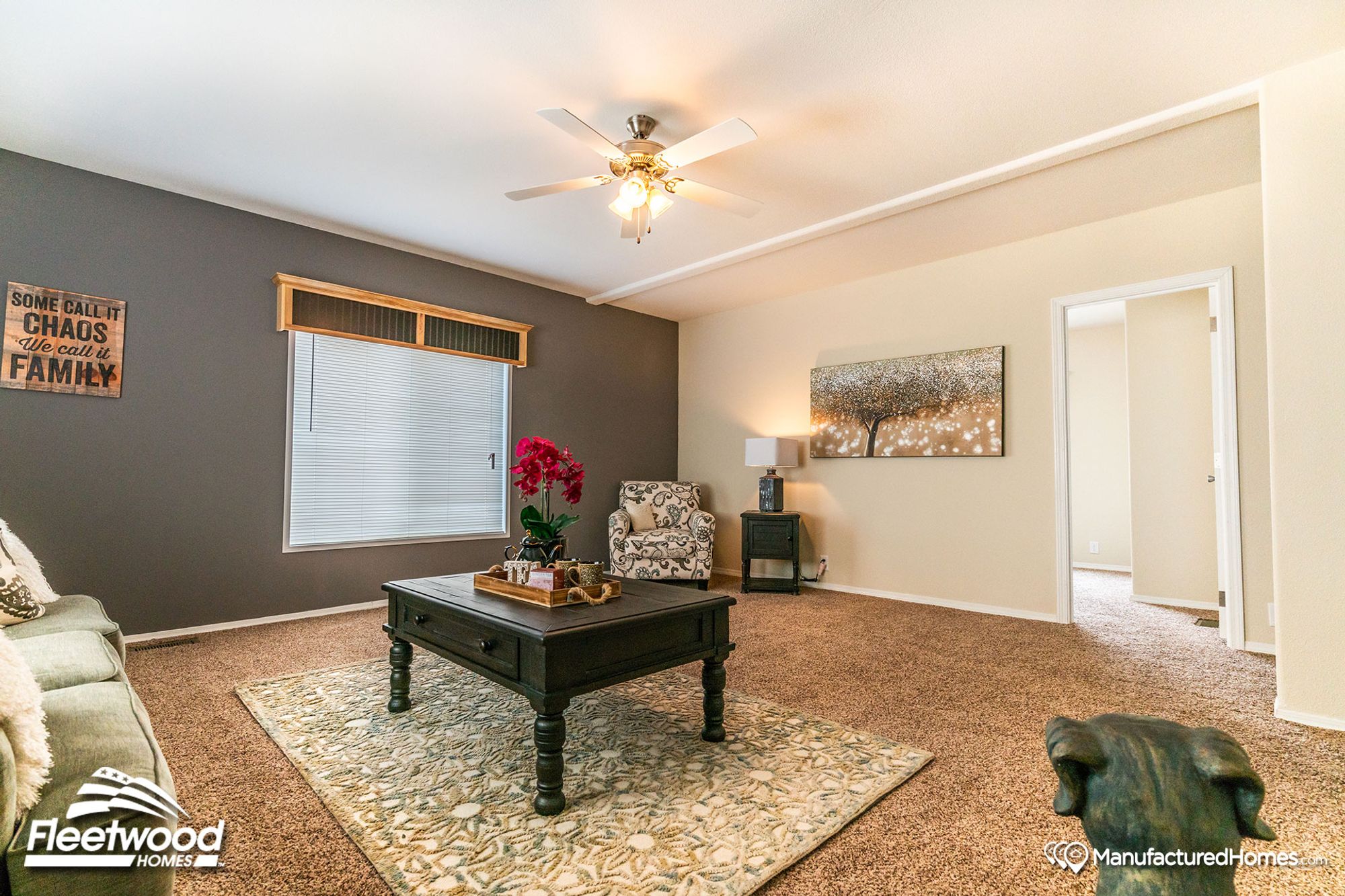 Large living room with a couch, a single chair, a coffee table, and a side table.