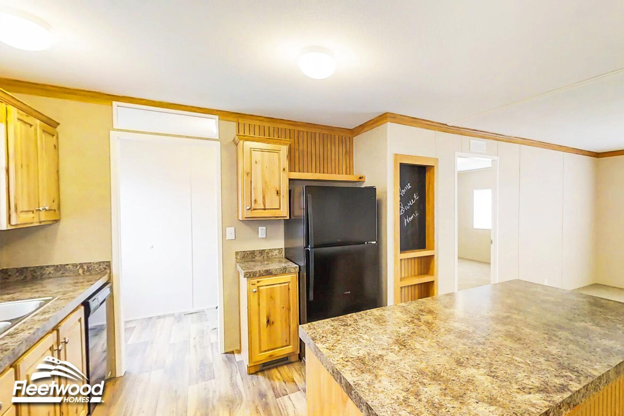 Cozy kitchen with wood cabinetry, island counter, and a chalkboard nook.