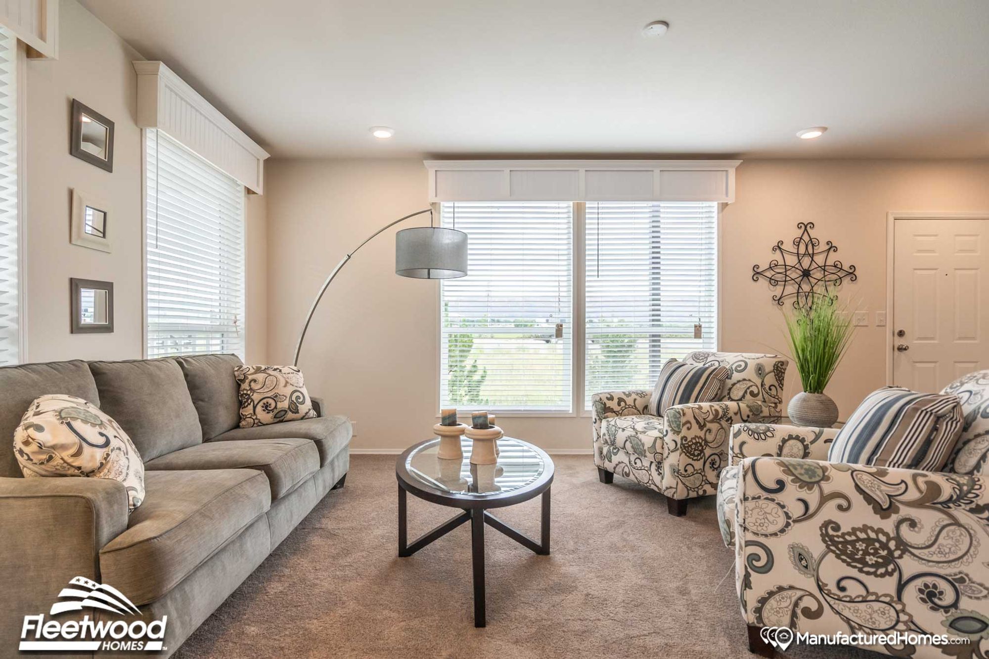 Large living room with two chairs and a couch.