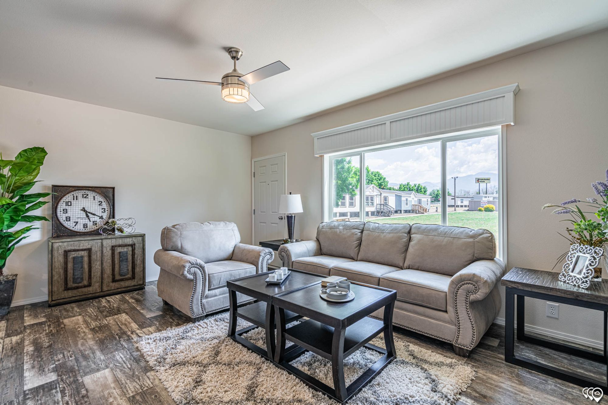 Front room with a large couch, a chair, a coffee table, and two side tables.
