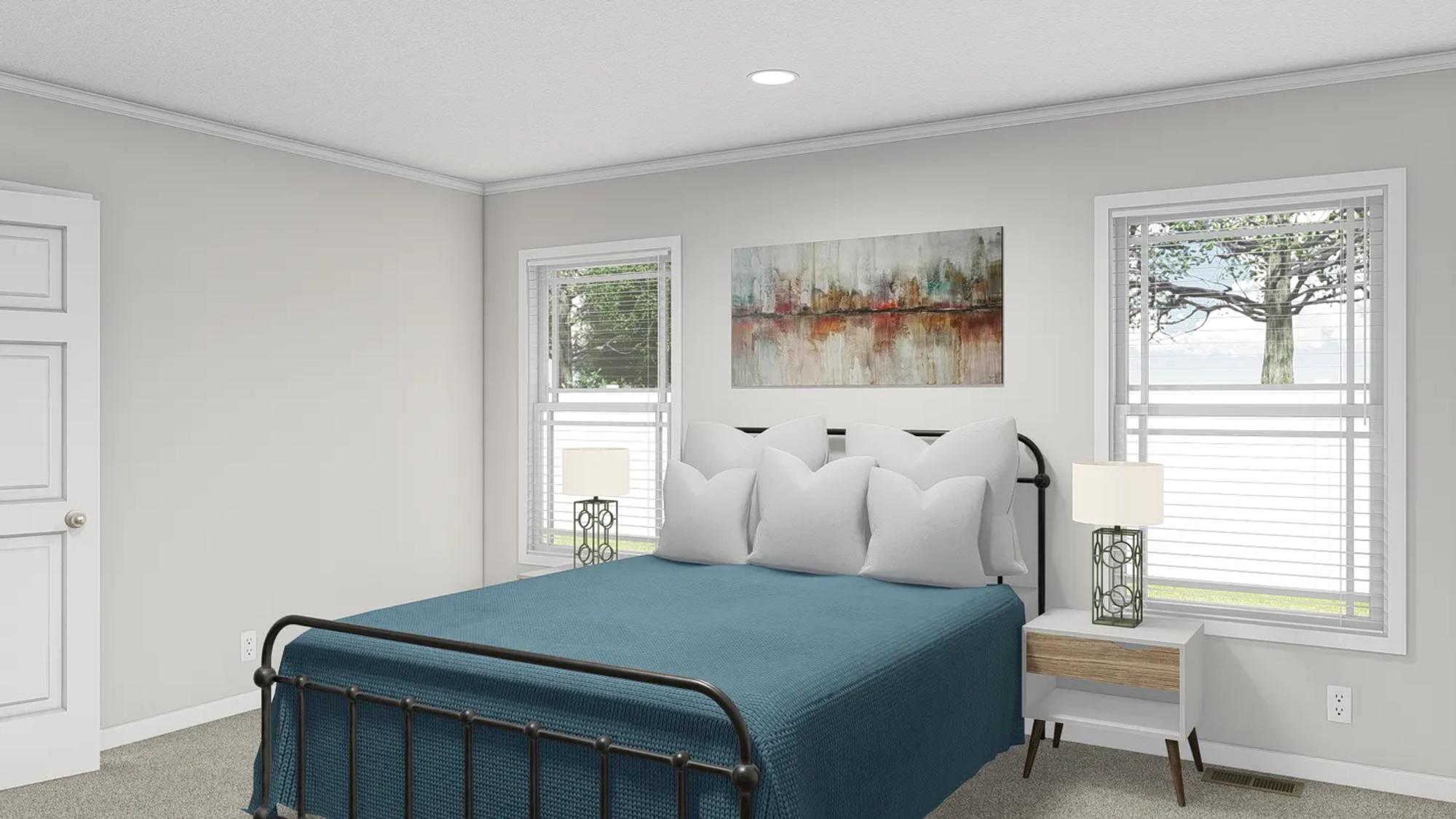 Bedroom with a bed featuring a blue bedspread and white pillows, two end tables with lamps, and a painting above the bed.