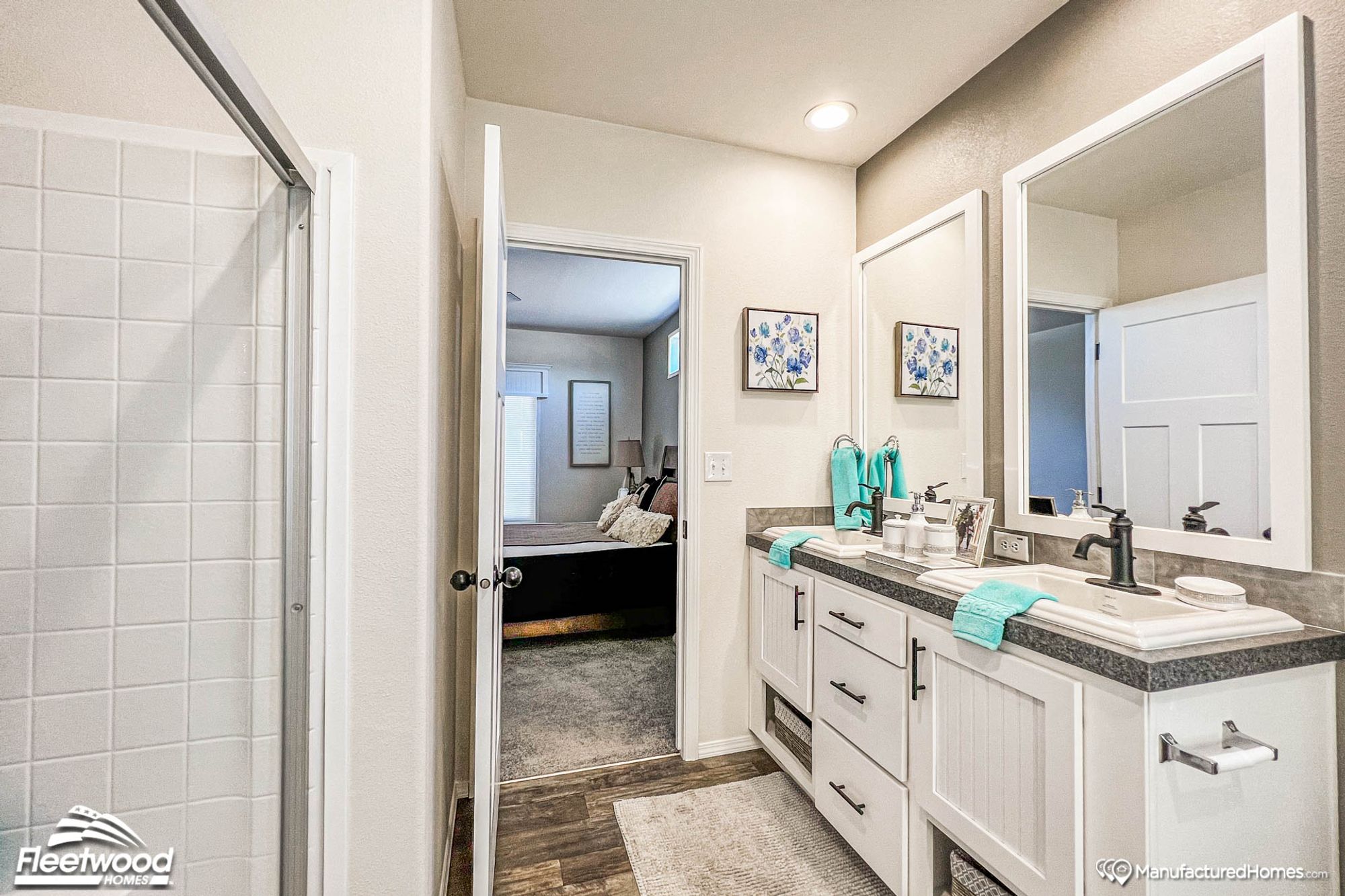 Partial view of a bathroom with a large countertop and two sinks.