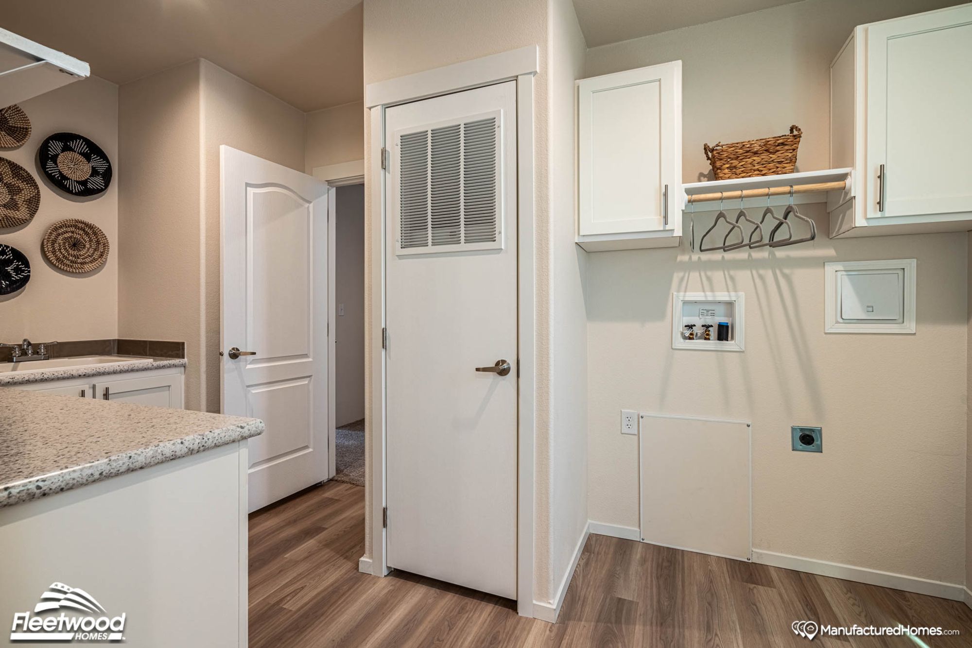 Partial view of a kitchen and the designated laundry hookup area.