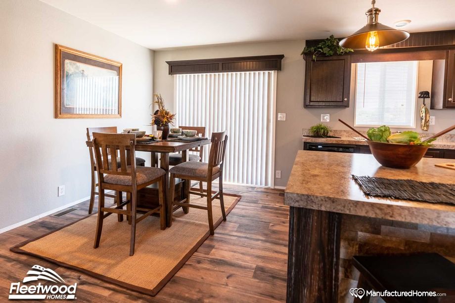 Large dining room with open access to the kitchen and a table that seats 4.