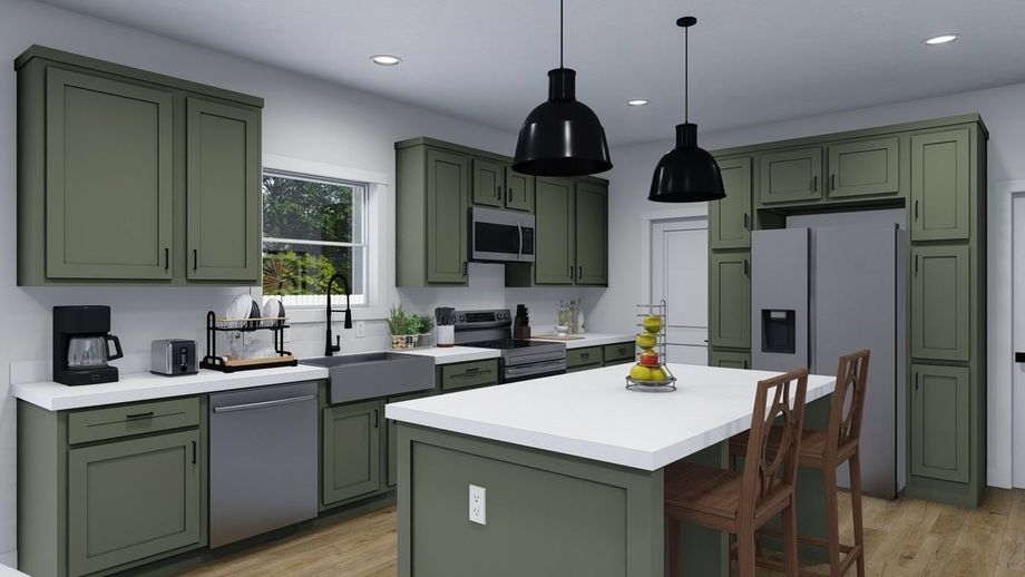 Large kitchen with green cabinetry, an island, white countertops, a farmhouse-style sink, and silver appliances.