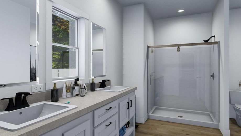Large, spacious bathroom with a large countertop featuring double sinks.