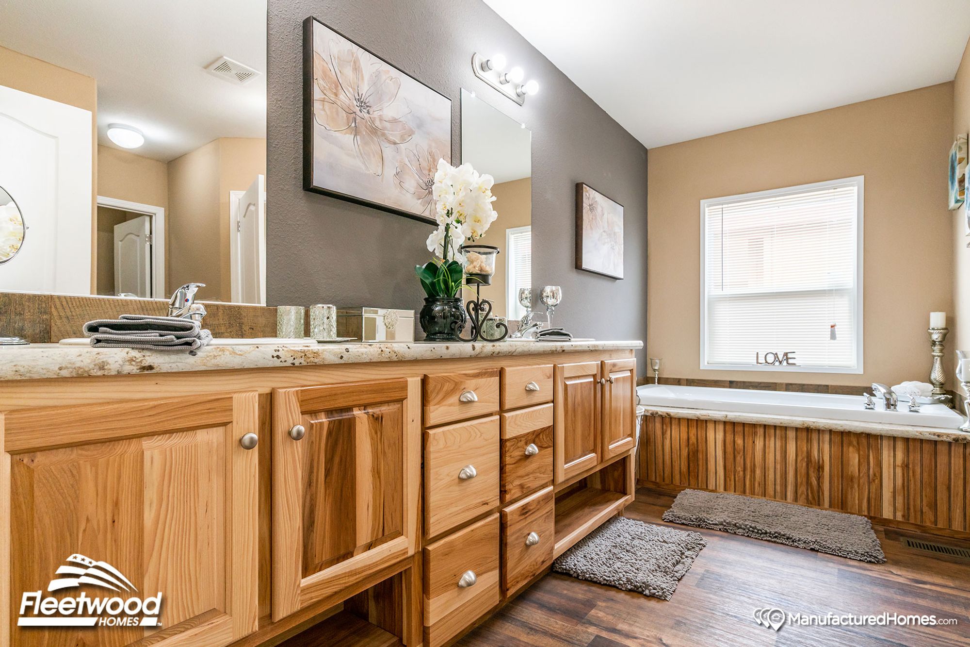 Mid-sized bathroom with a large bathtub and a countertop with a single sink.