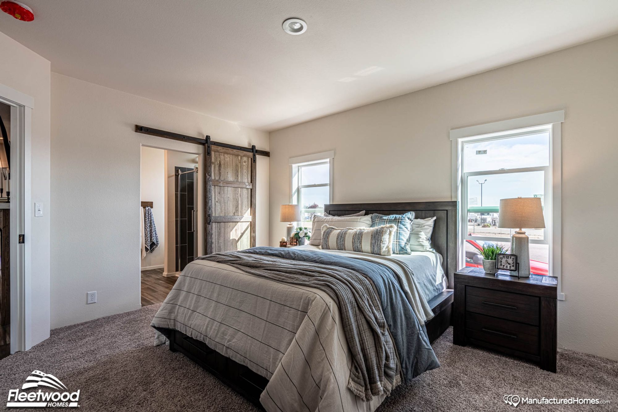 Medium-sized room with a queen bed and a partial view of the bathroom.