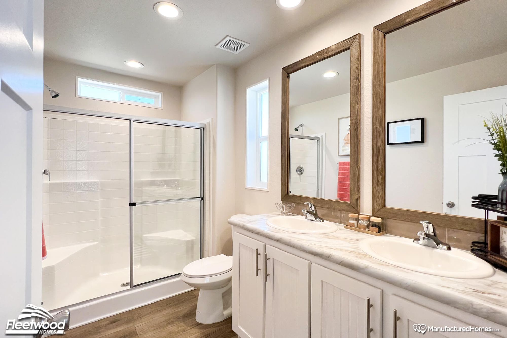 Close-up of a bathroom with a large bathtub and a spacious double-sink countertop.