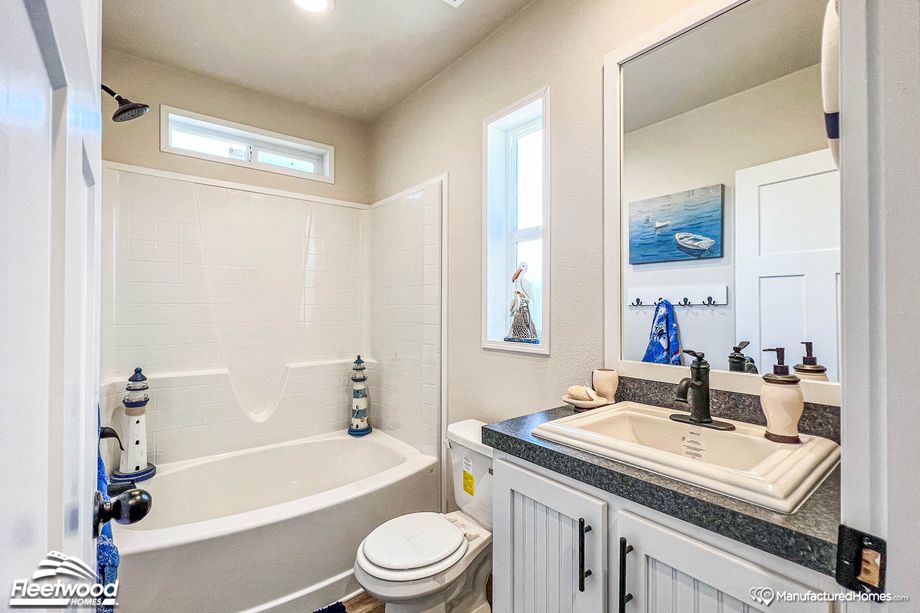 Small bathroom with a shower-bathtub combo and a single sink.