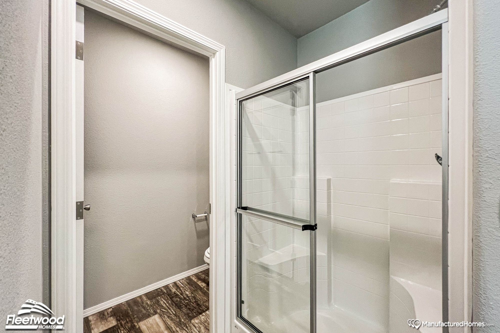 Close-up of a bathroom with a large standing shower.