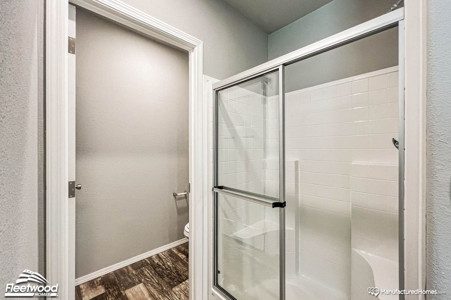Close-up of a bathroom with a large standing shower.