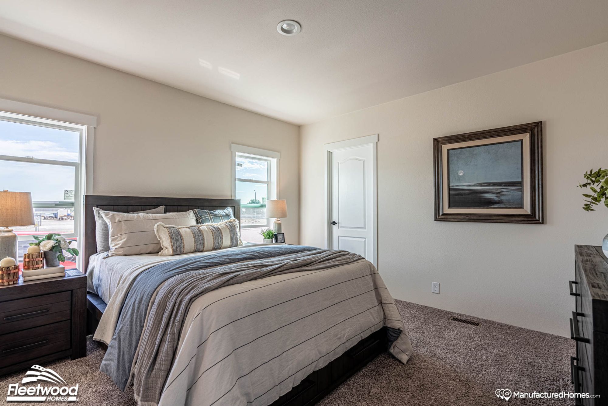 Medium-sized room with a queen bed and a partial view of the bathroom.
