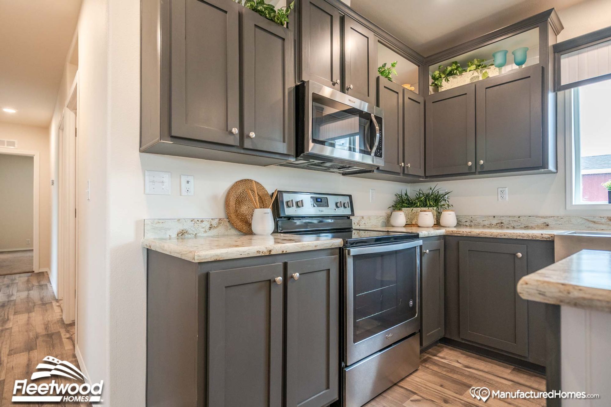 Close-up shot of a kitchen’s oven, adjacent counter space, and cabinets above.