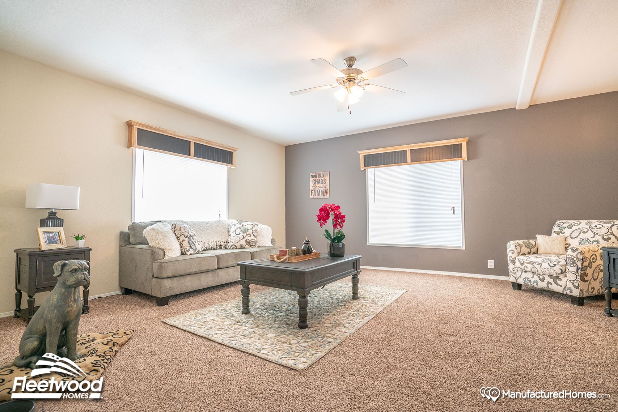 Large living room with a couch, a single chair, a coffee table, and a side table.