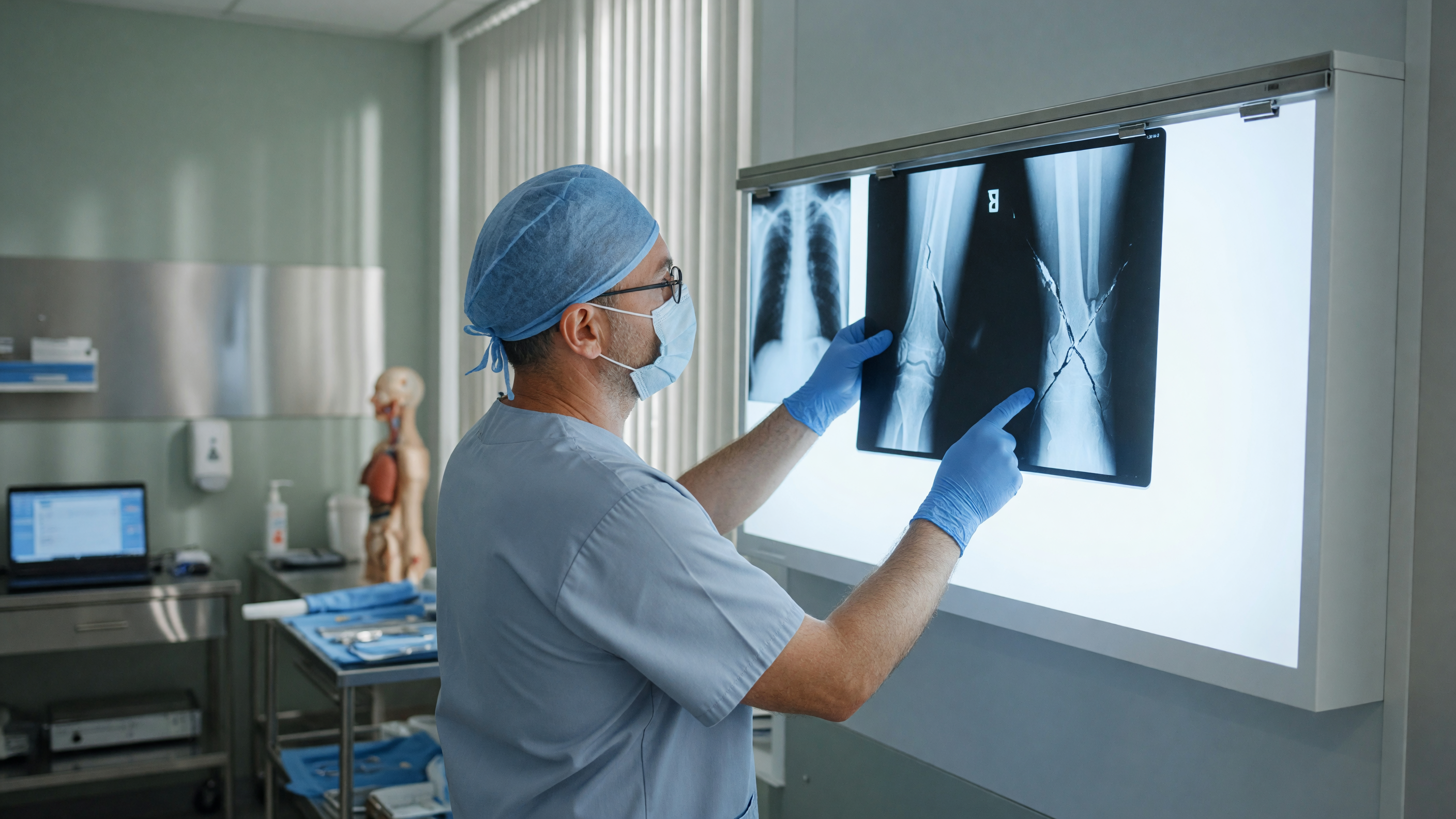 Doctor examining an X-ray showing bone fracture symptoms in a patient's limb