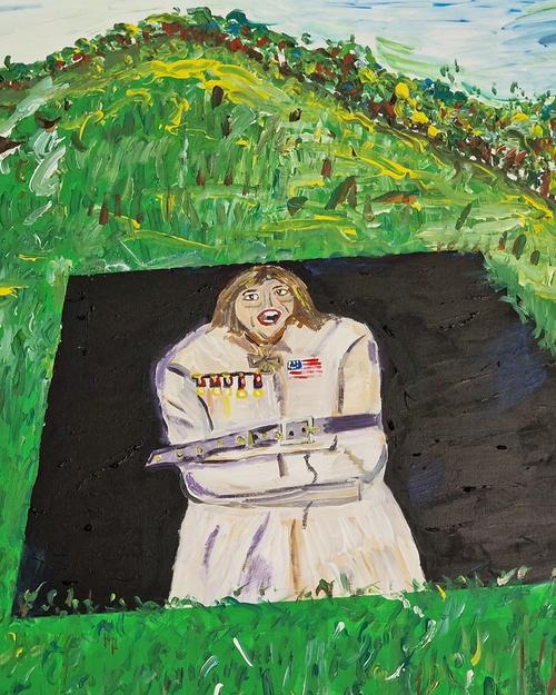 The lunatic lays on the grass