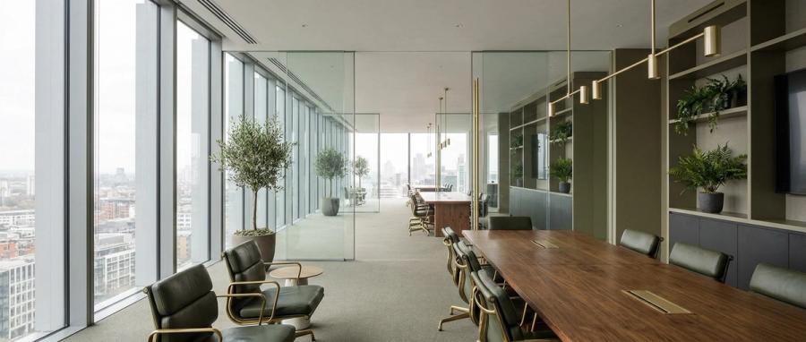 Modern upscale office interior with floor-to-ceiling windows and a conference table