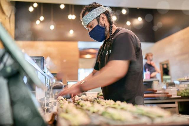 Bamboo Sushi employee preparing sushi.