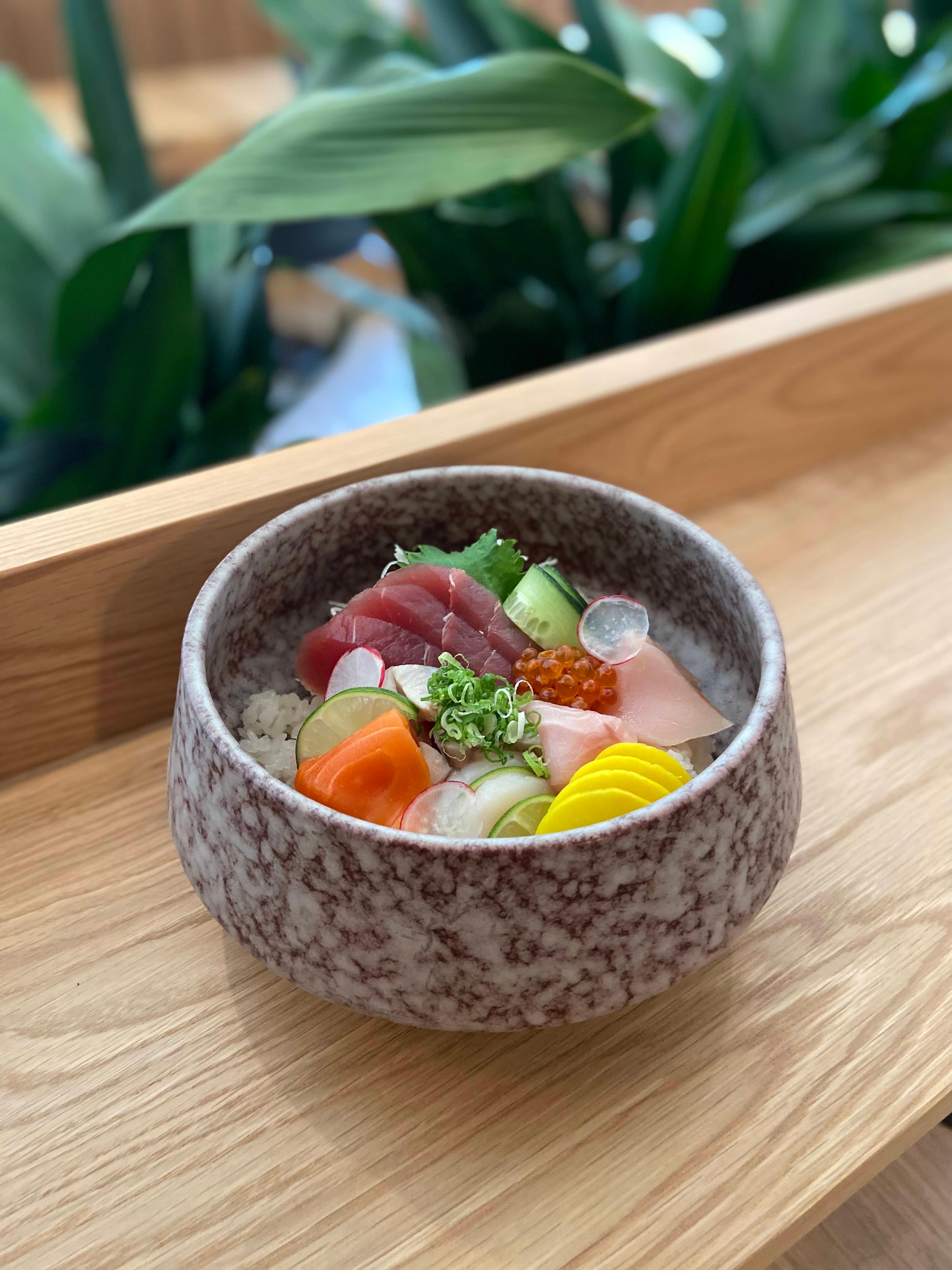 A chirashi bowl of assorted sashimi over rice.