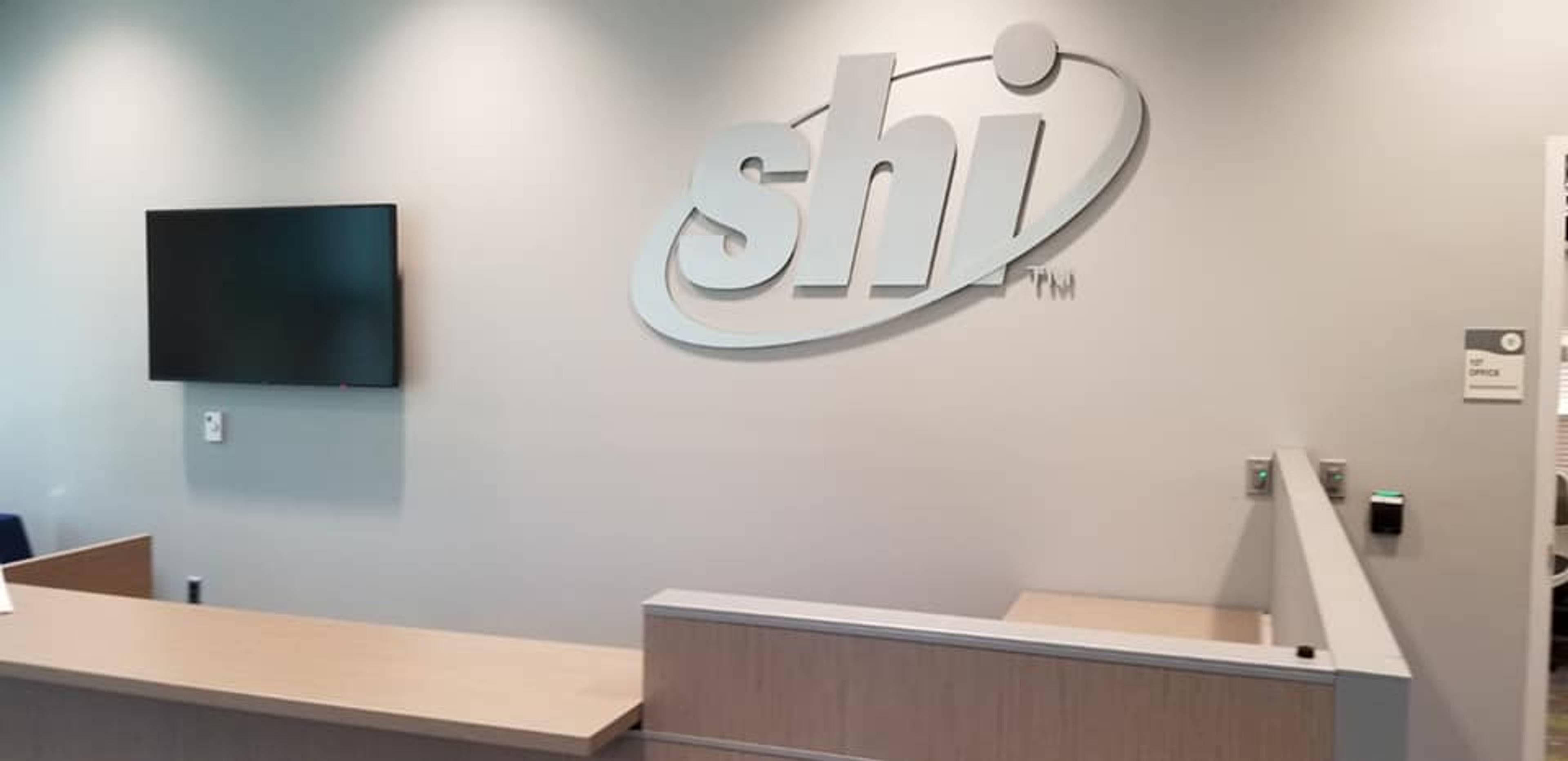 SHI office reception wall sign, large fabricated 3D logo letters in corporate lobby