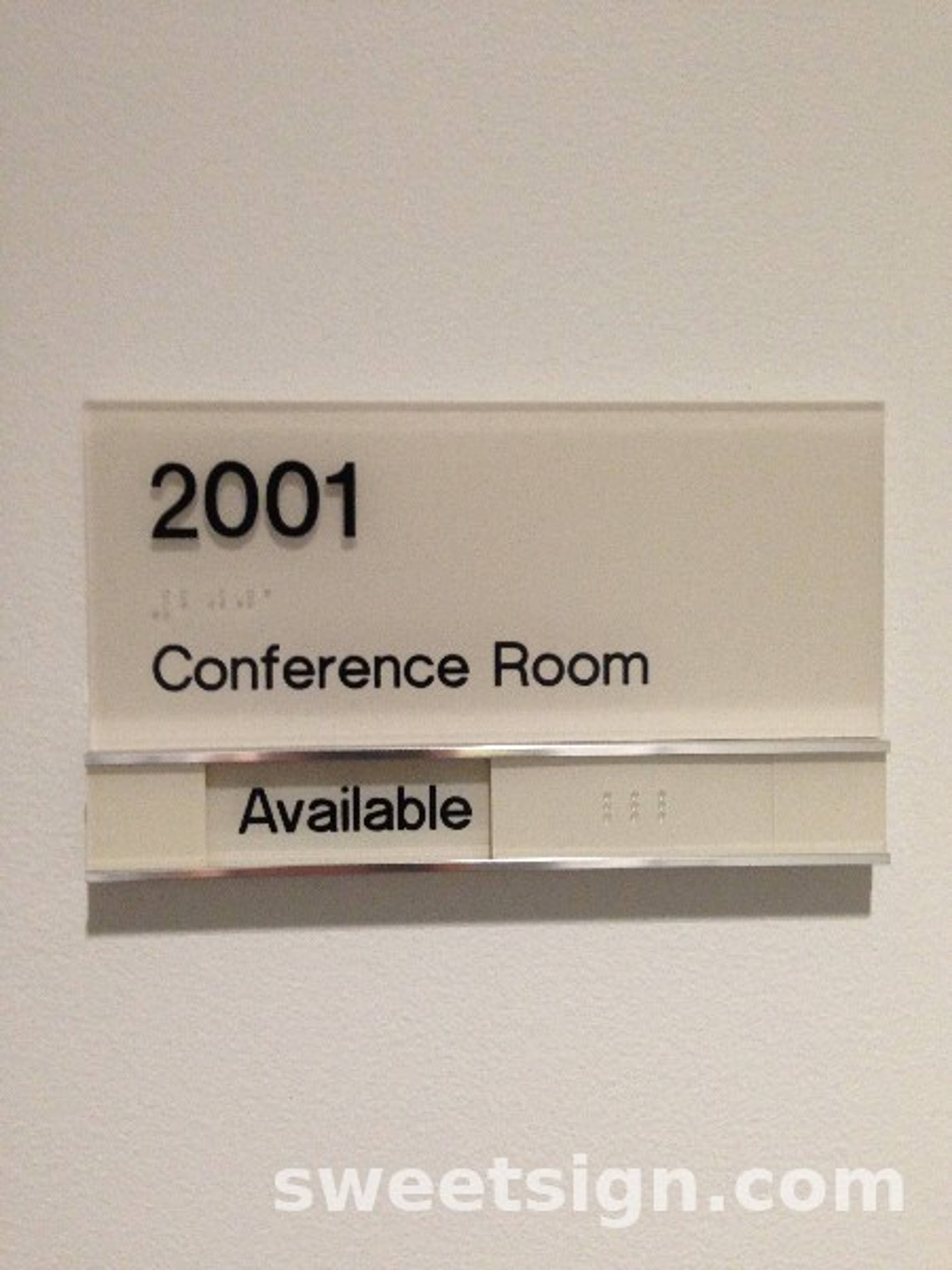 Conference room sign with room number and availability slider