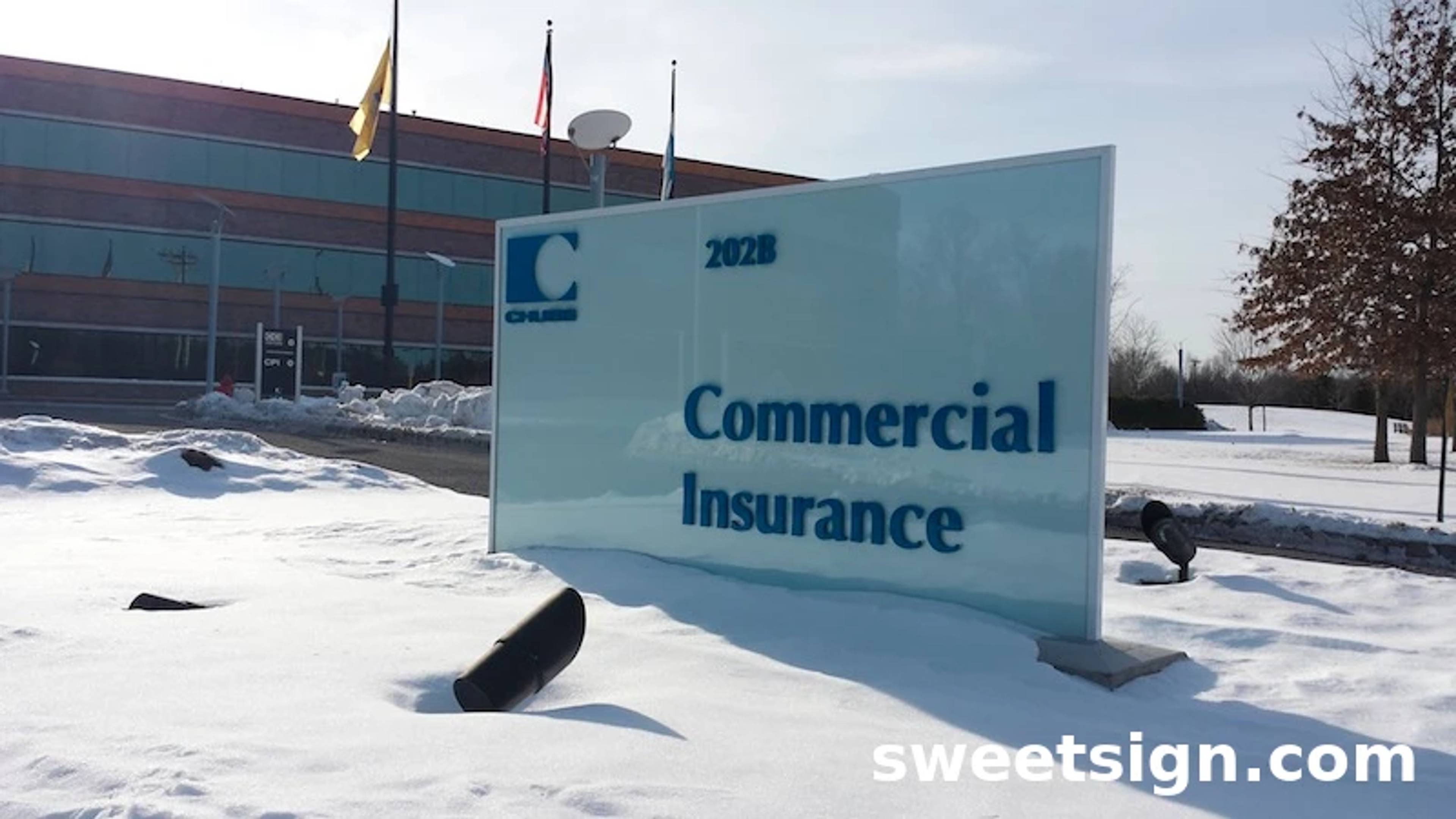 Commercial Insurance glass monument sign with corporate branding
