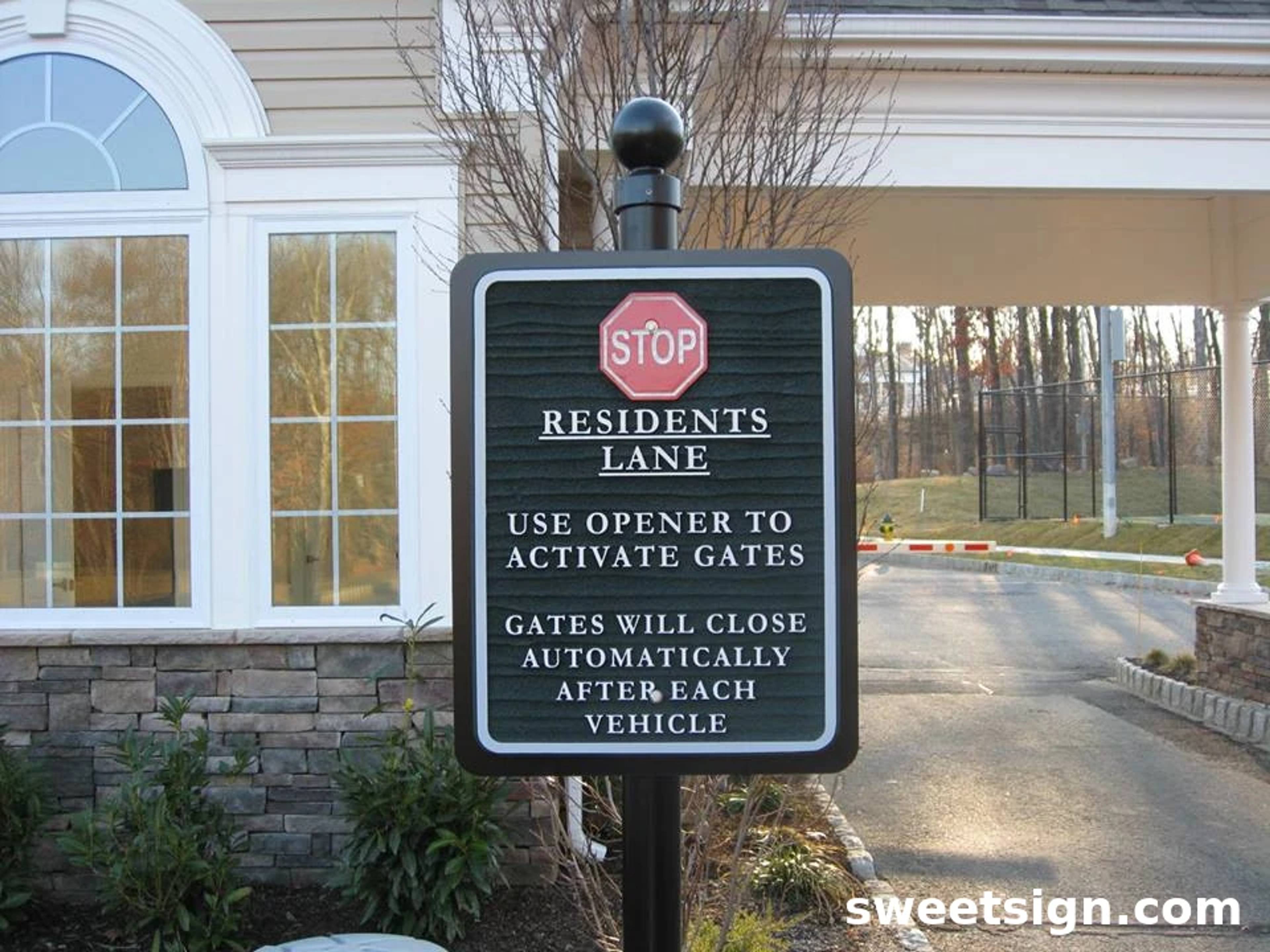 Residential lane gated entry sign with stop symbol