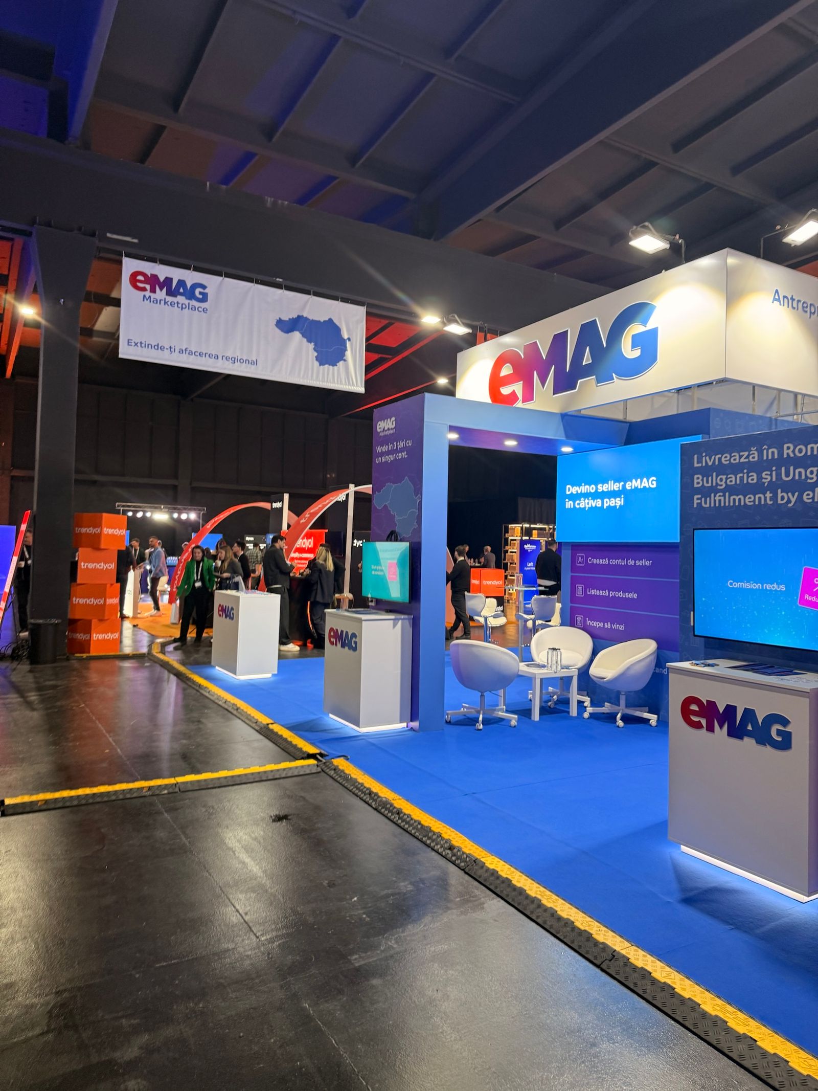 The eMAG Marketplace booth at The Base Event 2026, promising selling in 3 countries with one account and becoming a seller in a few steps.