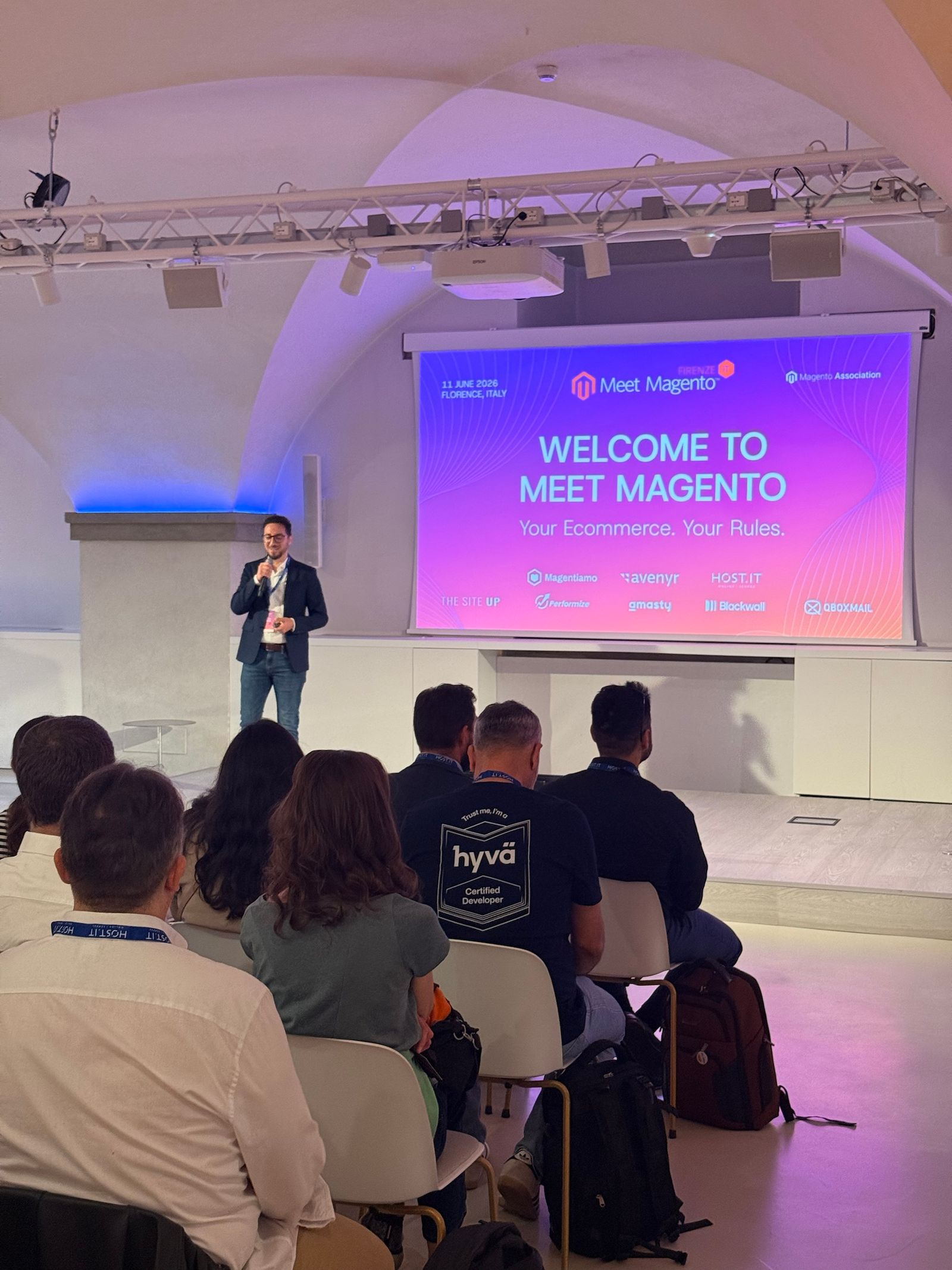 A full room at Nana Bianca for the opening session of Meet Magento Italy 2026, with “Welcome to Meet Magento” on the screen.