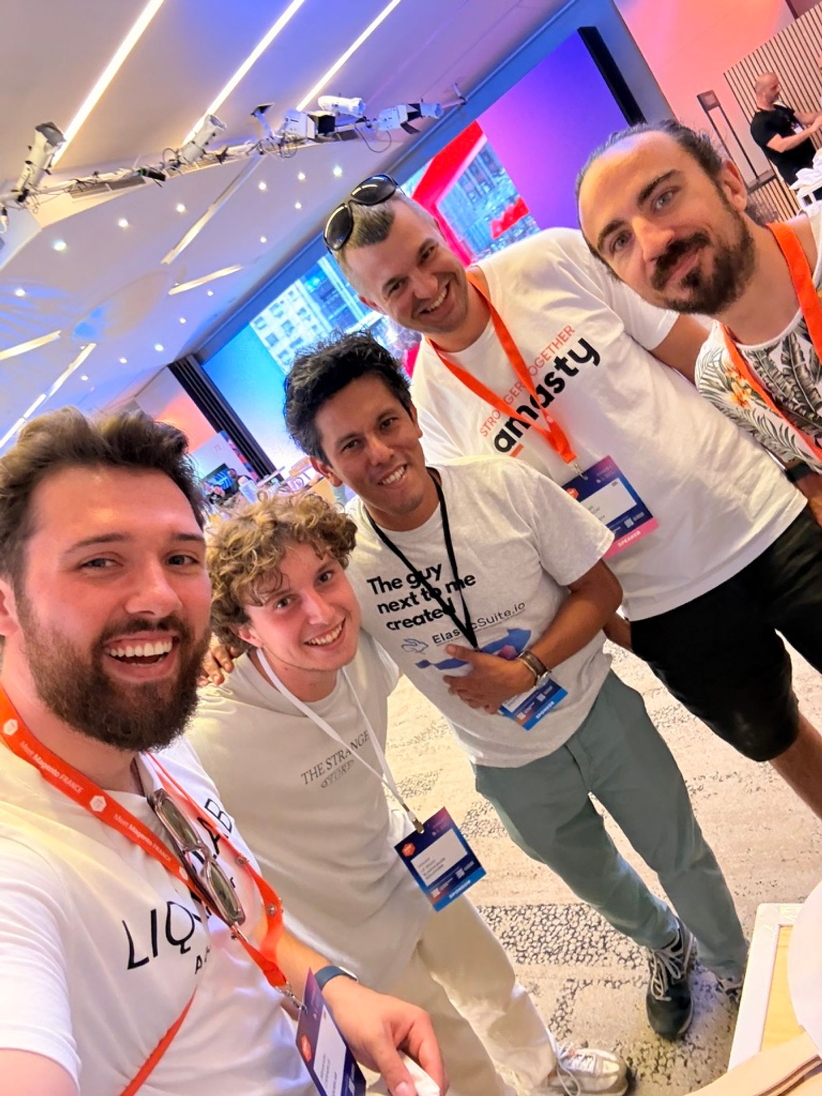 Alexandru-Manuel Carabus of LiquidLab with fellow attendees at MM France 2026, including a member of the Amasty team in a Stronger Together t-shirt.