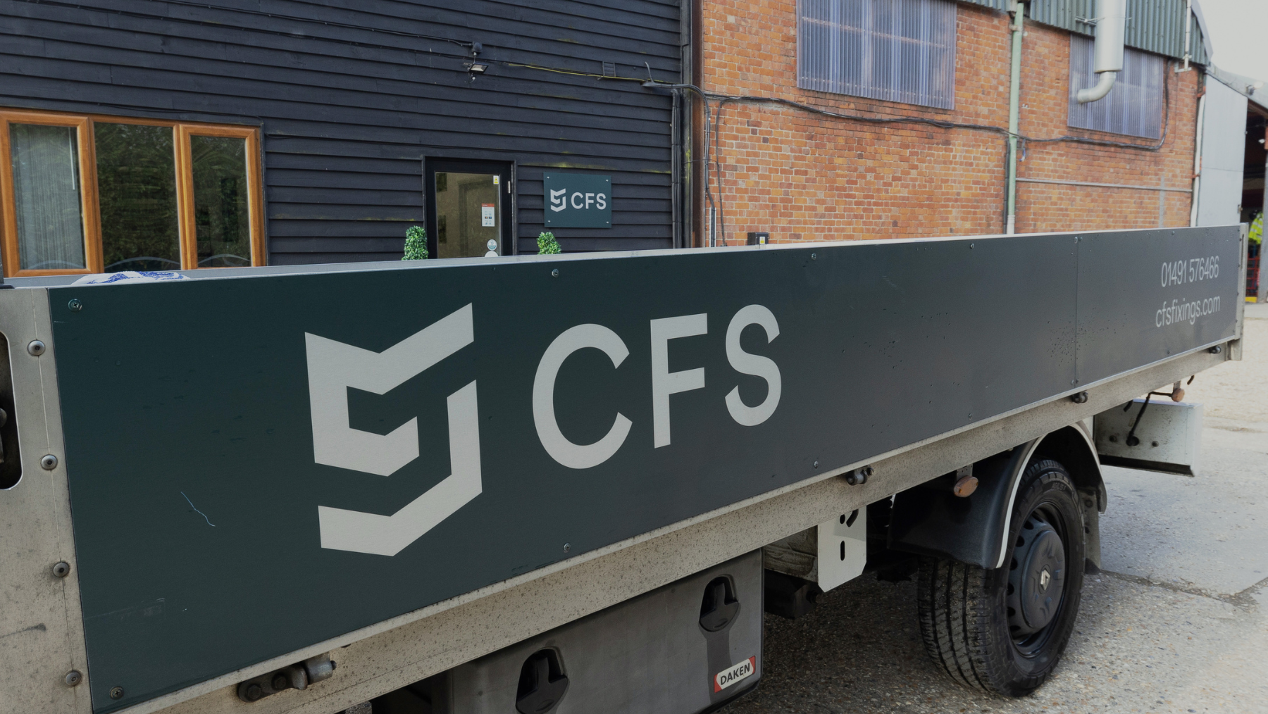 Construction Fixing Systems Ltd branded truck in front of the main building