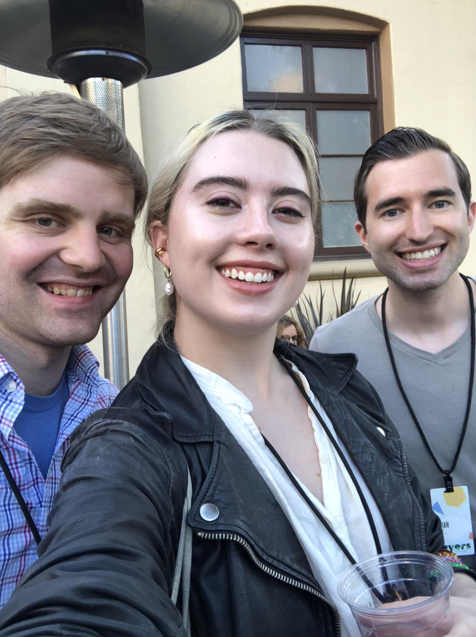 A photo of mb, Jillian, and Brian wearing their Layers badges