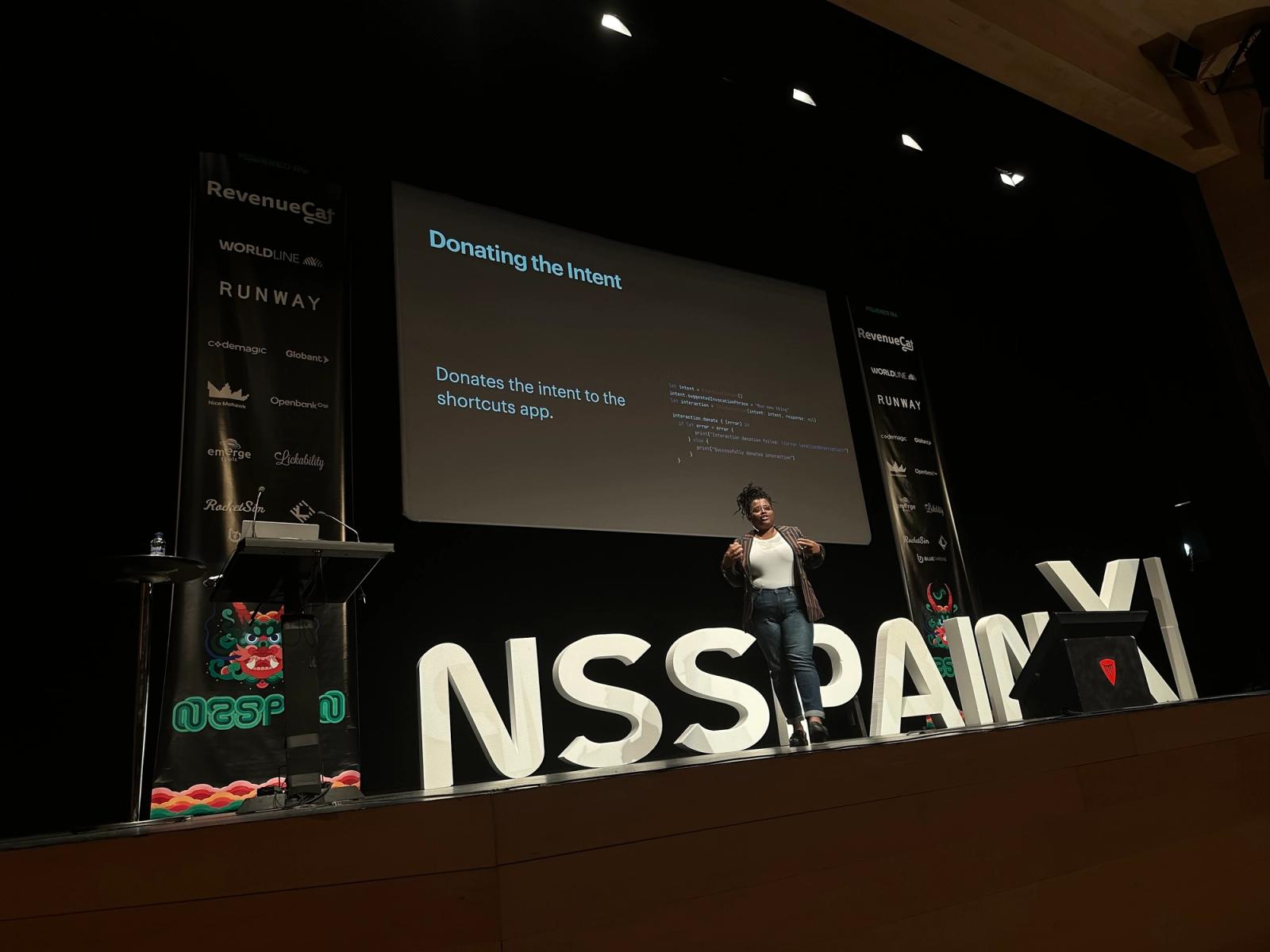 Ashli on stage at NSSpain giving her talk