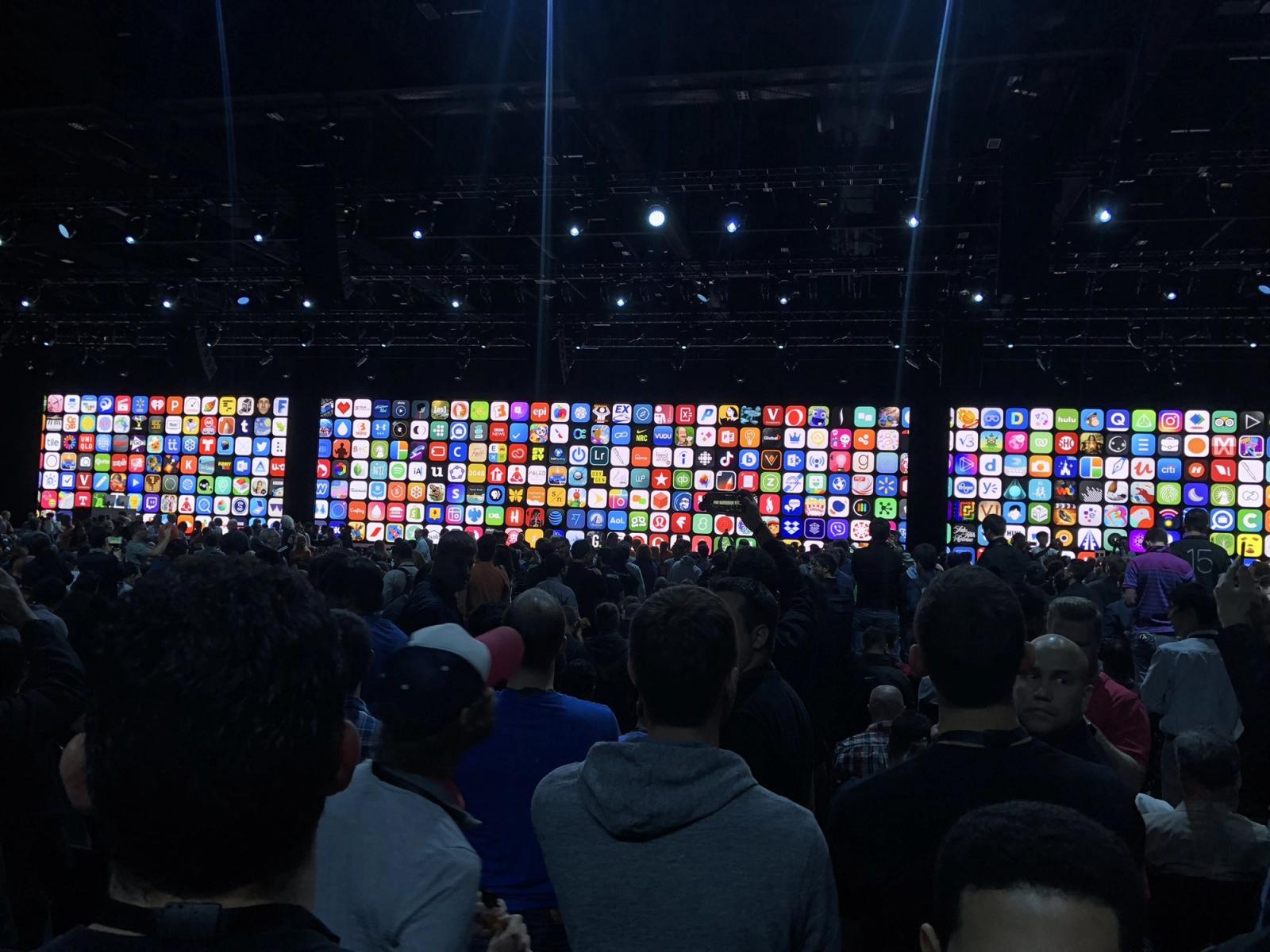 A photo from the opening keynote of WWDC 2018 showing a wall of app icons.