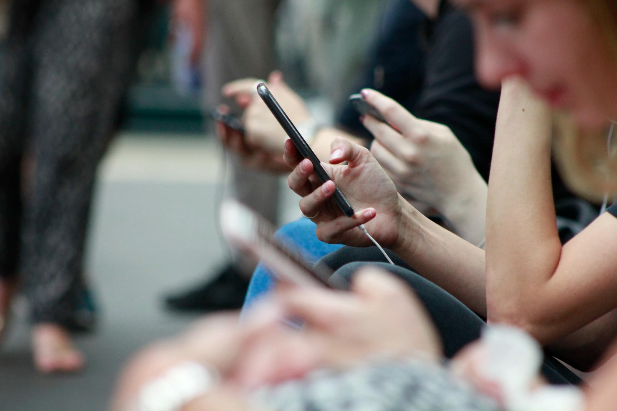 A person's hand holding a smartphone