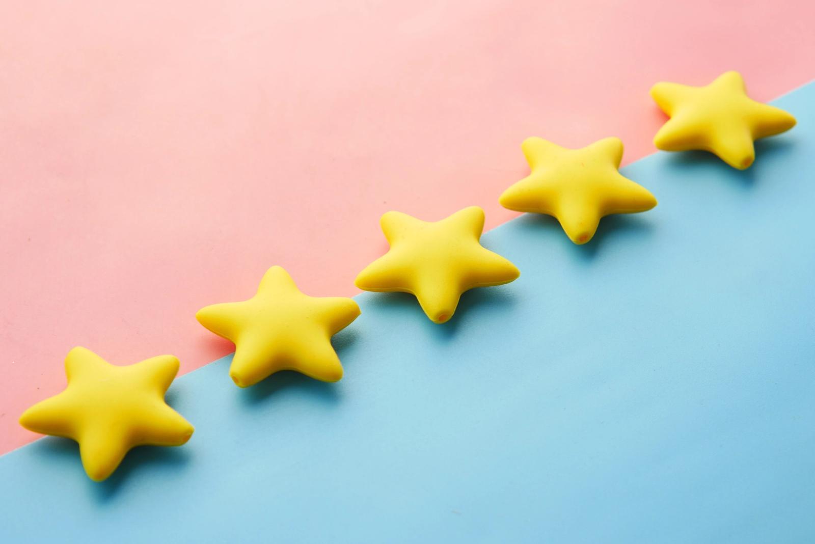 A row of yellow stars on a pink and blue background