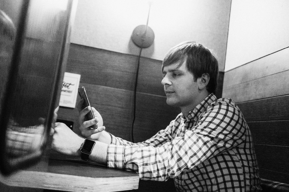 Matt sitting in a phone booth.