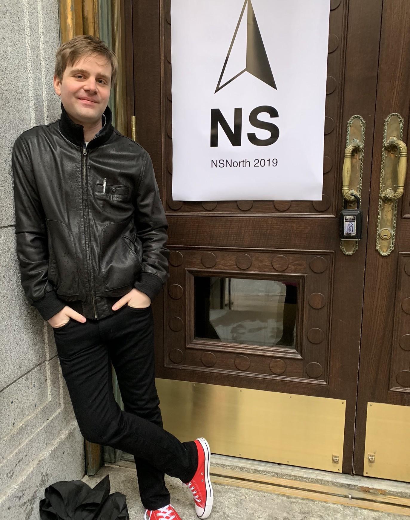 mb outside the conference, in front of a sign that says NSNorth 2019.