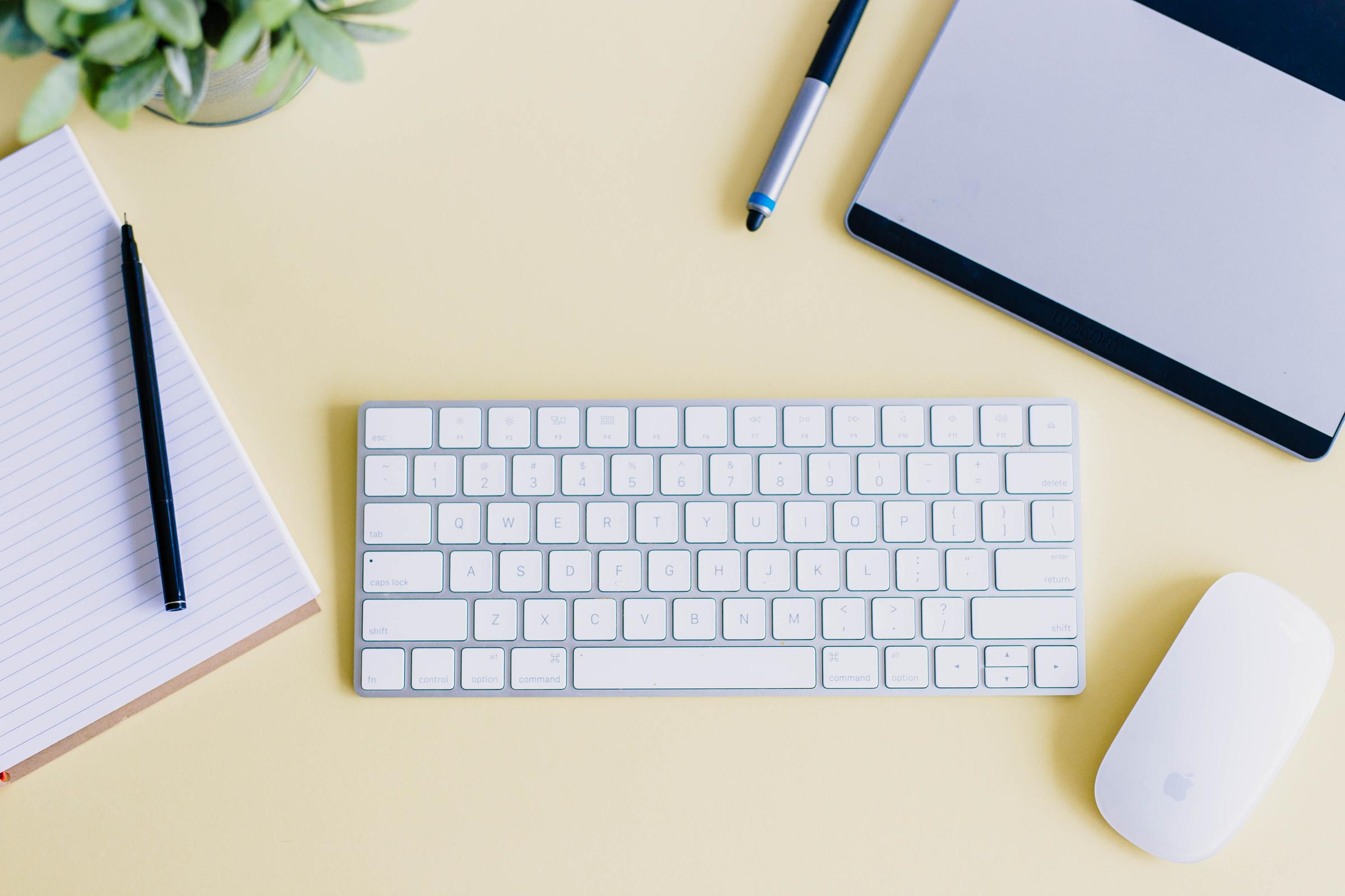 Keyboard on a yellow desk.