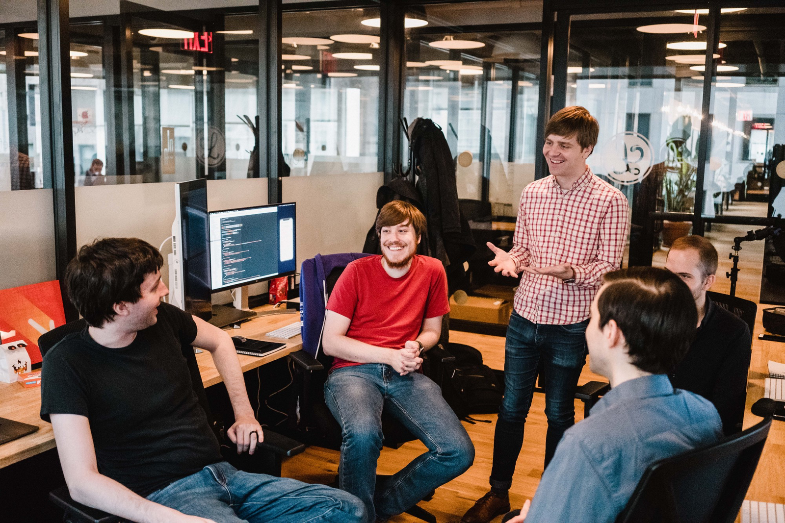 Matt standing in a circle of Lickability team members, gesturing.